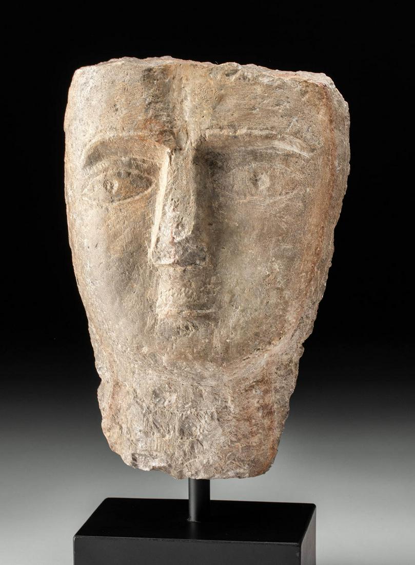 Fine South Arabian Qatabanian Stone Head: Ancient Middle East, South Arabia, Qatabanian culture, ca. 3rd century BCE. A beautiful example of a head from a funerary stela that is hand-carved from gray hardstone, perhaps schist, with a band of 