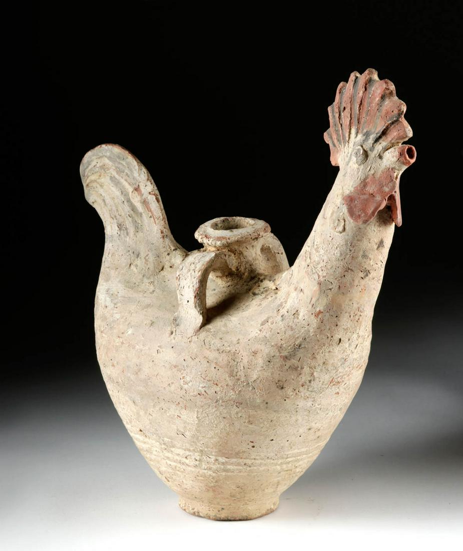 Medieval Islamic Pottery Rooster Vessel, TL Tested: Islamic world, Medieval Period, ca. 1000 CE. A delightful ceramic ewer in the form of a rooster, with a heart-shaped body. Extending from one side is the tall neck and head of the animal, with a brigh