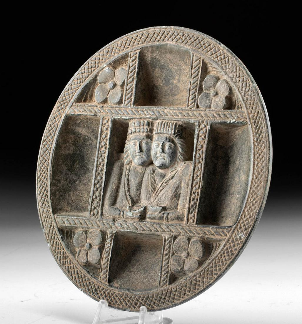 Gandharan Schist Cosmetic Plate w/ Figural Busts: Ancient Central Asia, Afghanistan, India, and Pakistan, Gandharan Empire, ca. 2nd to 3rd century CE. An interesting cosmetic plate carved from dark gray-green schist that features a pair of anthropomo