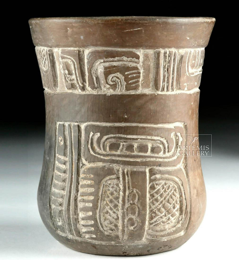 Mayan Brownware Vessel w/ Carved Glyphs: Pre-Columbian, Mayan Territories, Guatemala, Maya, Post-Classic Period, ca. 550 to 900 CE. A hand-built brownware pottery cylinder incised with a register of glyphs along the upper body as well as a p