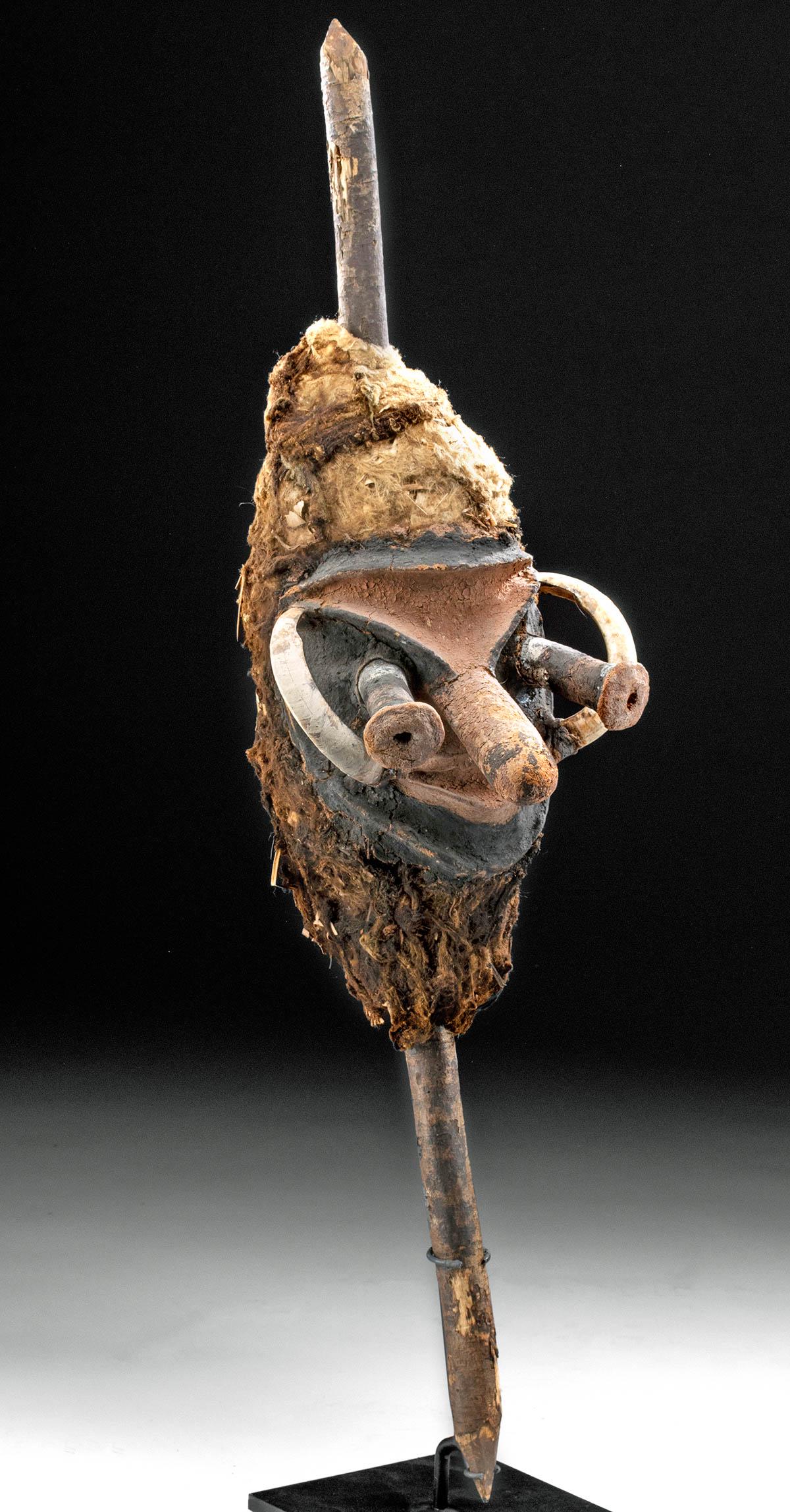 Dramatic 19th C. Melenesian Vanuatu Mask Phallic Nose: Melanesia, Vanuatu Island, ca. 19th century CE. A dramatic mask carved from wood and accented with applied red-brown pottery, with a long, phallic nose, bulging eyes that project almost as far out fro
