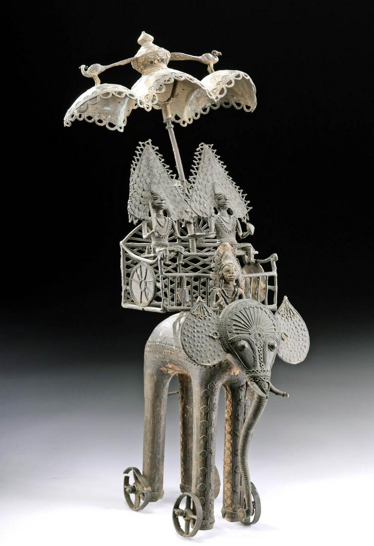 Early 20th C. India Bastar Brass Elephant, Howdah, Gods: Central Asia, India, Bastar, ca. early 20th century CE. A large antique Bastar cast brass ensemble featuring an elephant on wheels who is carrying a howdah (a large basket-like form with a grand canop
