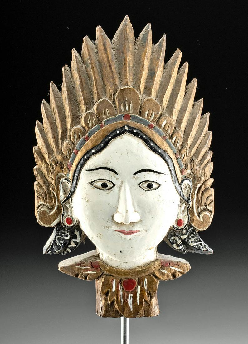Early 20th C. Indonesian Painted Wood Head of a Batari: Southeast Asia, Indonesia, ca. early to mid 20th century CE. A striking wooden head, carved and painted, depicting a batari or batara, a goddess or god. The face is dramatically white, with black pain