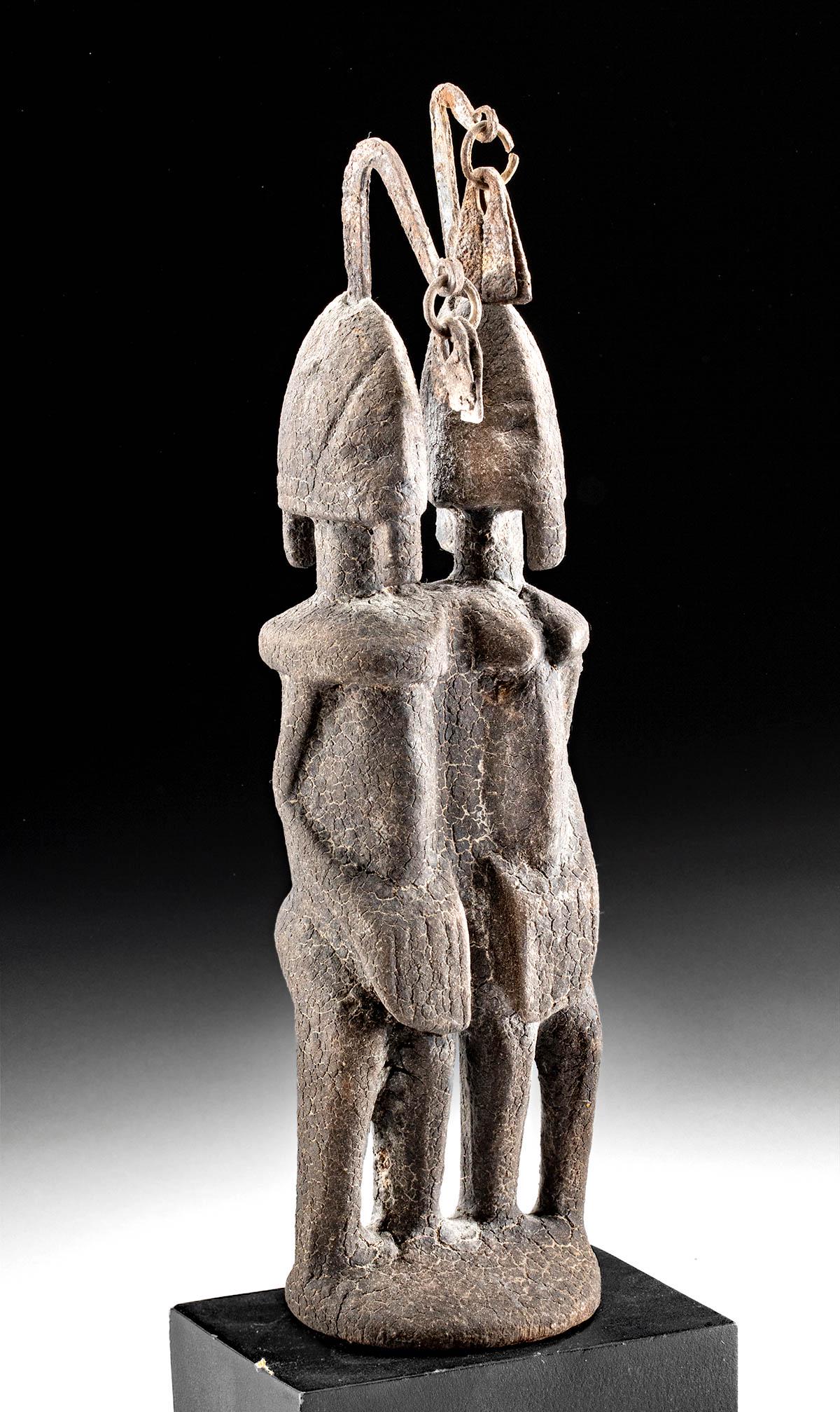 20th C. Mali Dogon Wood & Iron Conjoined Ancestors: West Africa, Mali, Dogon peoples, ca. early to mid-20th century CE. An attractive set of conjoined ancestral figures carved from wood that stand atop a shared, integral plinth. Each figure holds both 