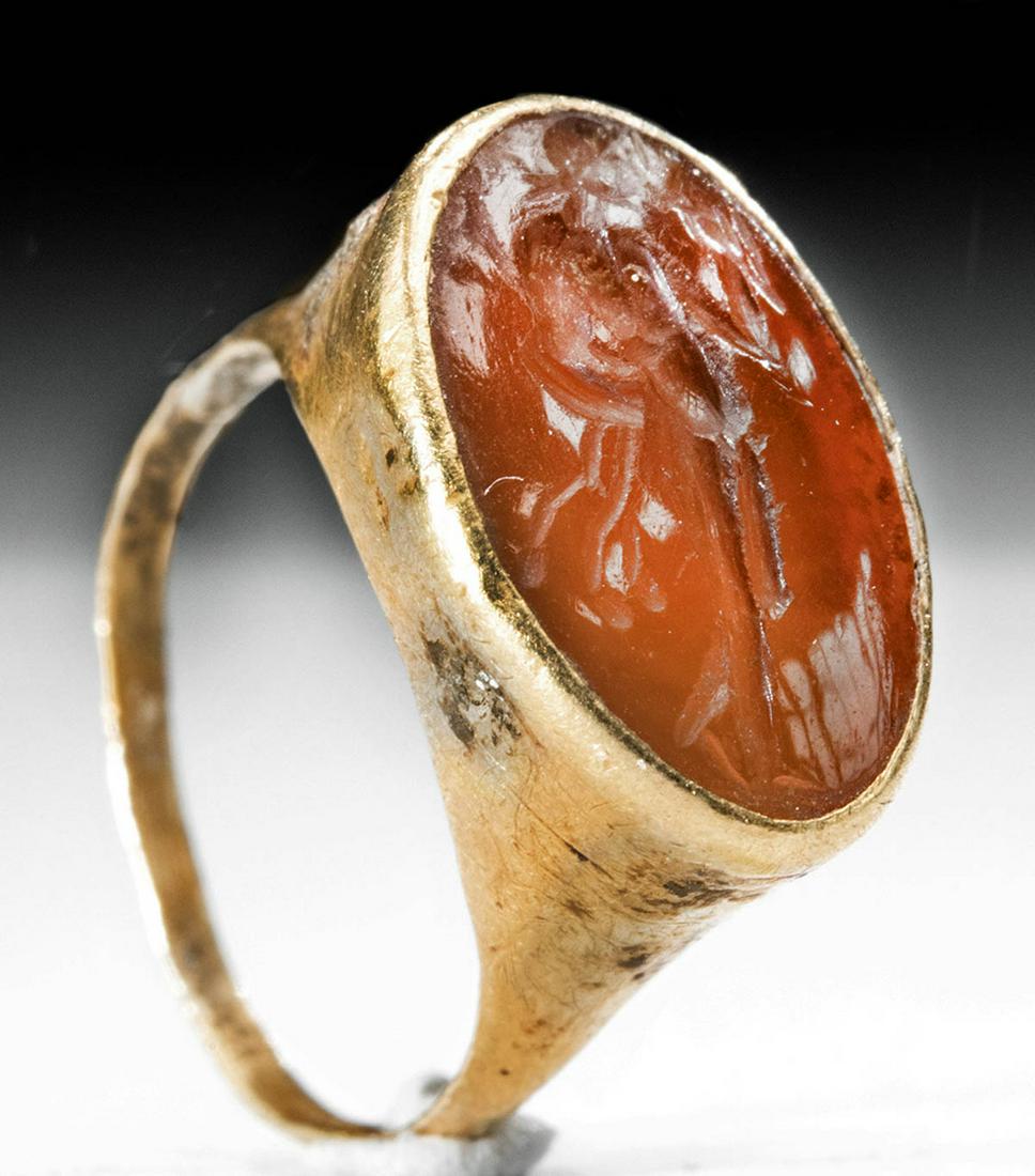 Roman 20K Gold Ring Carnelian Intaglio of Bacchus: **Originally Listed At $1000** Roman, Imperial Period, ca. 2nd century CE. A delightful gold ring, its size suggesting that it was made for a precocious child or woman with tiny hands, featuring an ex