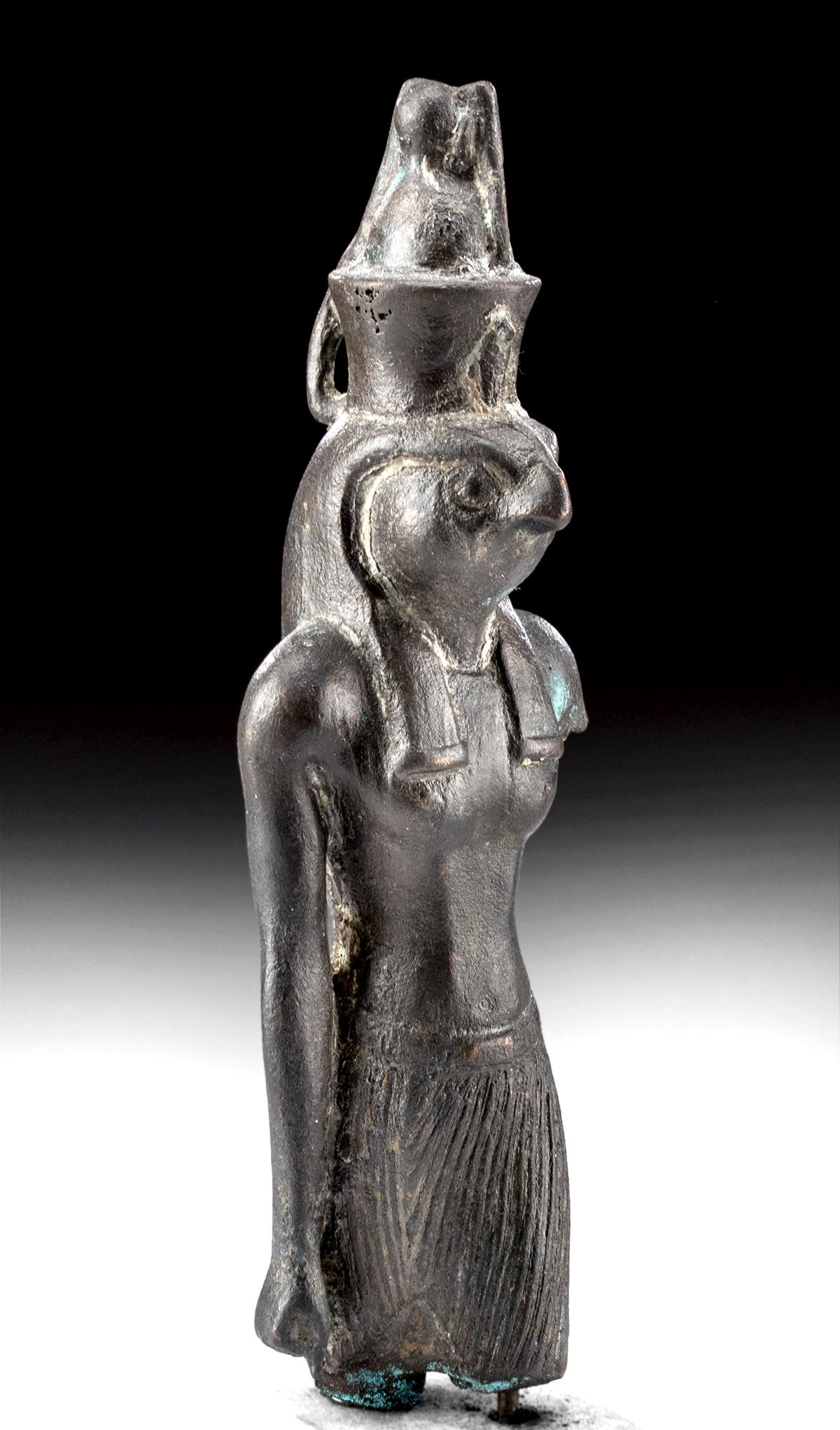 Egyptian Bronze Statue Falcon-Head God Horus: Ancient Egypt, Third Intermediate Period, 21st to 25th Dynasty, ca. 1069 to 664 BCE. A remarkable Egyptian copper alloy statue of the god Horus formed using the lost-wax casting process. Striding forw