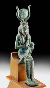 Impressive Egyptian Bronze Isis and Horus: Egypt, Late Dynastic to Ptolemaic Period, ca. 664 to 30 BCE. A beautiful and quite sizeable cast-bronze sculpture of the goddess Isis-Hathor seated with her right hand held to her bare breast ready