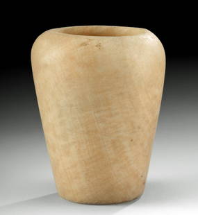 Near-Miniature Egyptian Ptolemaic Alabaster Jar: Ancient Egypt, Ptolemaic Kingdom, ca. 305 to 30 BCE. Finely carved from beautiful alabaster, an ovoid vessel with a flat base and tall walls that gently flare to a broad rounded rim. This type of