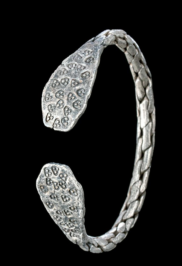 9th C. Viking / Norse Braided Silver Bracelet: Northern Europe, Viking or Norse culture, ca. 9th to 11th century CE. An exquisite Viking bracelet composed of high-quality (86%) silver and presenting a stunning design with a 'braided' style and res
