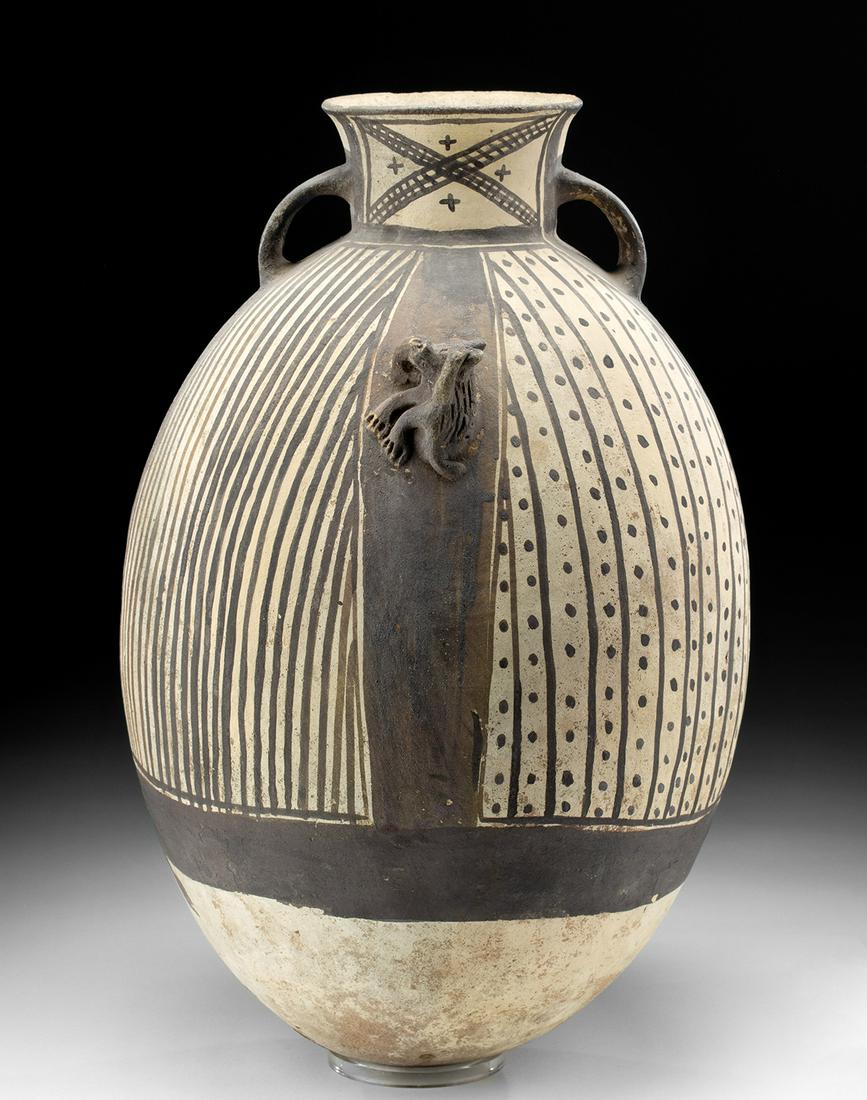 Large Chancay Bichrome Pottery Jar w/ Monkey: Pre-Columbian, Central Coast Peru, Chancay, ca. 1000 to 1300 CE. A large hand built pottery vessel, egg-shaped with black geometric patterns over a beige surface. The short neck is decorated with a la