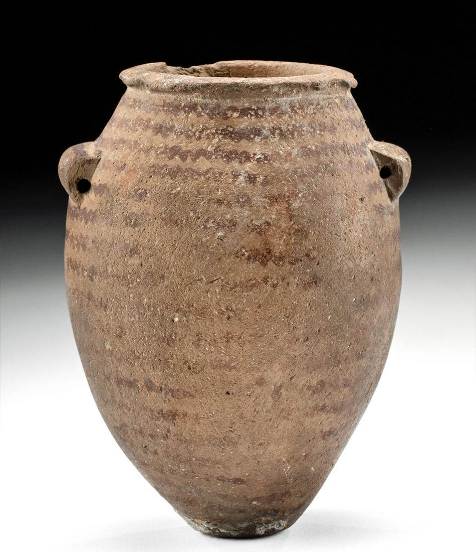 Egyptian Predynastic Naqada II Bichrome Acorn Jar: Ancient Egypt, Predynastic Period, Naqada II, ca. 3500 to 3200 BCE. A beautiful and incredibly early buffware vessel of an elongated form with an acorn-shaped body resting atop a narrow base. The piri