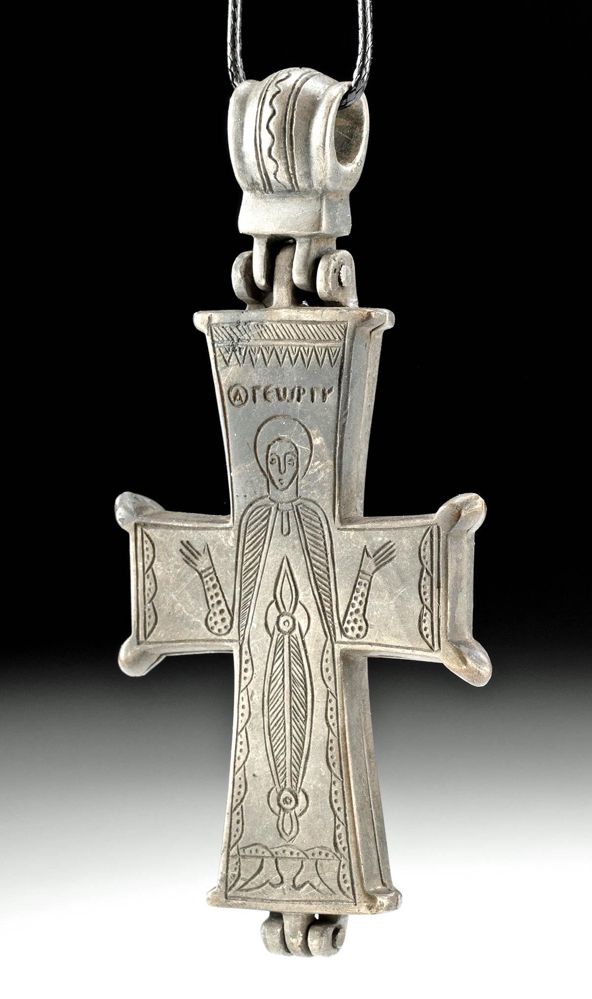 Byzantine Silver Alloy Reliquary Cross W/ St. George: Ancient Near East, Holy Land, early Byzantine Empire, ca. 7th to 8th century CE. A beautiful cast-silver alloy reliquary cross comprised of two crucifixes which fit together incised with an open-armed