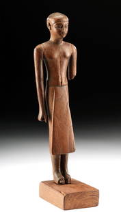 Fine Egyptian 12th Dynasty Wood Standing Dignitary: Egyptian, Middle Kingdom, 12th Dynasty, ca. 1991 to 1783 BCE. Skillfully carved from a single piece of wood, a male figure who stands upright with disciplined posture, his arms held tightly to his