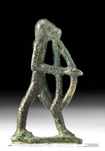 Exhibited Rare Egyptian Bronze Baboon Atum-Ra Votive: Egypt, Late Dynastic Period, 26th to 31st Dynasty, ca. 664 to 332 BCE. A cast leaded bronze standing baboon figure holding a bow and arrow, representing the seventh hour of the daytime sun. He stands