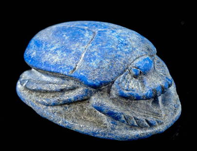 Egyptian Lapis Lazuli Scarab Amulet: Egypt, New Kingdom / Third Intermediate Period, ca. 1550 to 664 BCE. A stunning scarab amulet finely carved from brilliant blue lapis lazuli, complete with stylized legs, face, and winged shell. The