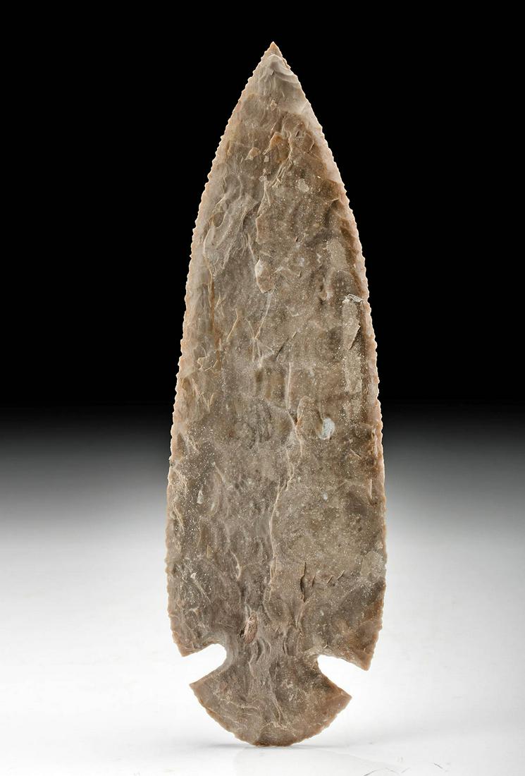 Aztec Flint Sacrificial Knife: Pre-Columbian, Valley of Mexico, Aztec culture, ca. 1200 to 1532 CE. A finely knapped flint knife of light and dark brown hues that was perhaps used in sacrificial rituals. The petaloid blade has slig