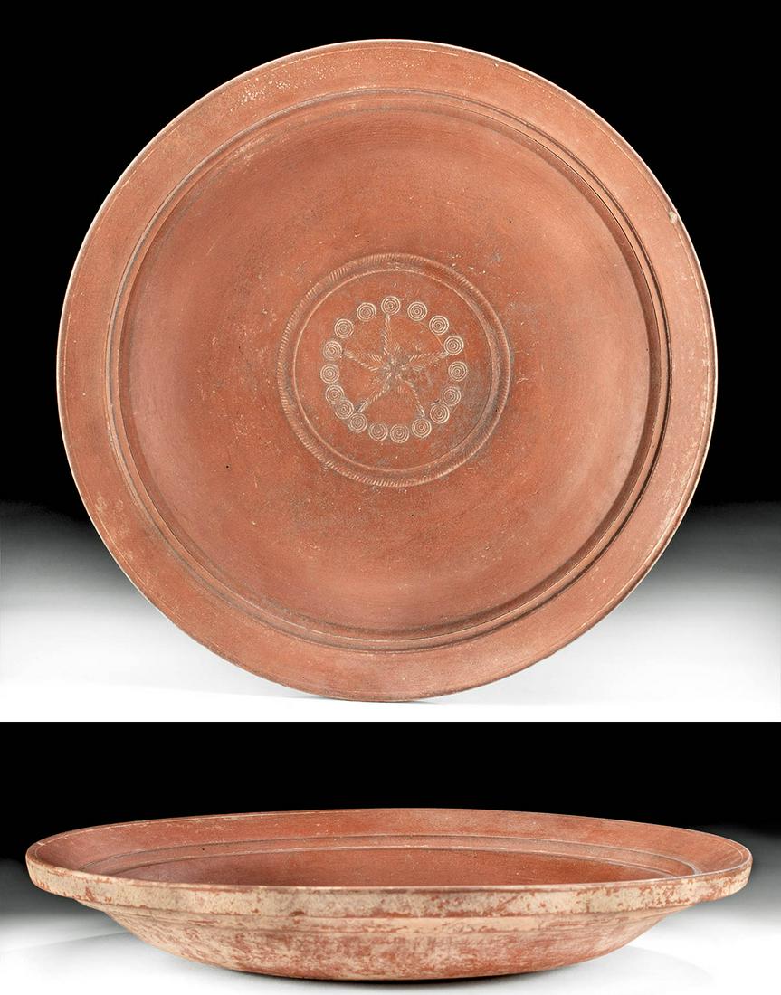 Roman N. African Terra Sigillata Dish w/ Stamped Motifs: Roman, North Africa, Imperial Period, ca. 3rd to 4th century CE. A lovely wheel-thrown redware pottery dish of a squat form that rests atop a flat base. The vessel features broad walls, a shallow basi