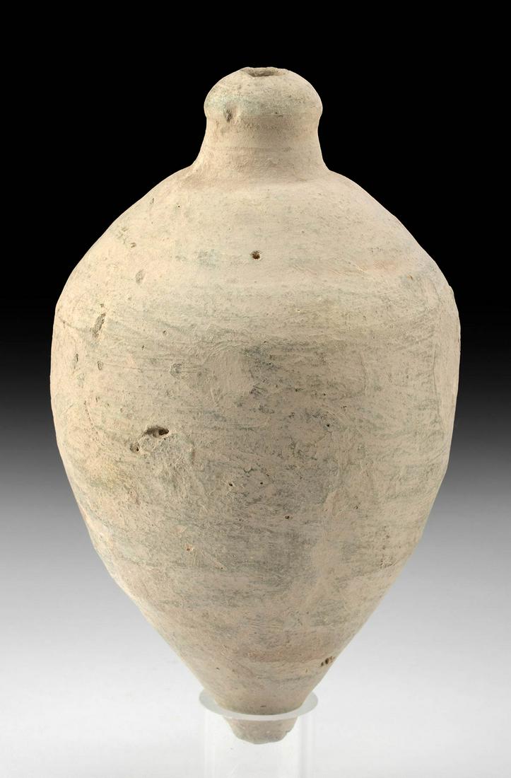 9th C. Byzantine Pottery Hand Grenade: Ancient Near East, Holy Land, Byzantine Empire, ca. 9th to 11th century CE. A hand-built pottery hand grenade of an elongated, acorn-shaped form with a gradually sloped shoulder and a narrow wick spou