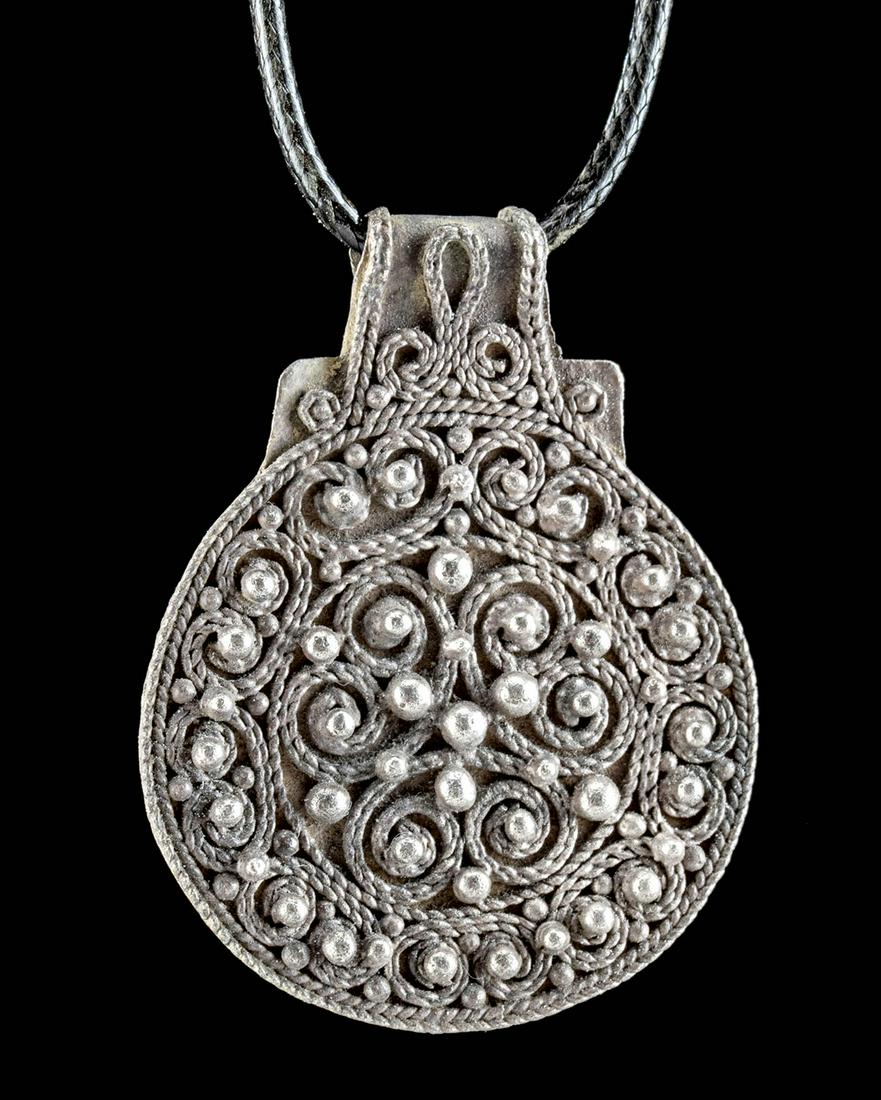 Viking Silver Bracteate Pendant w/ Granulation - 5.8 g: Northern Europe, Scandinavia, Viking or Norse culture, ca. 9th to 10th century CE. A gorgeous and rare bracteate pendant, made from 98% silver. The surface is decorated with granulated and filigreed m