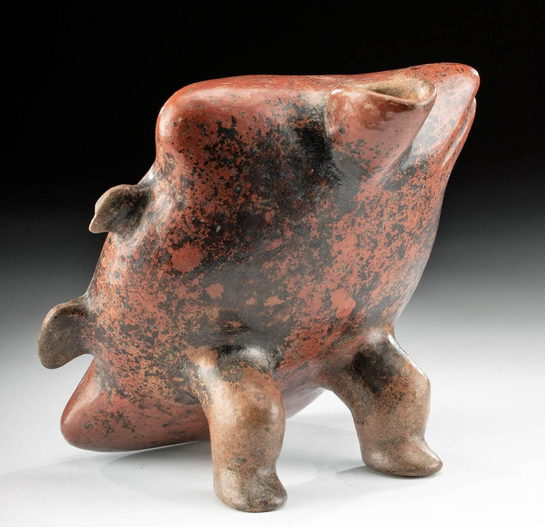Colima Redware Spouted Reclinatario Vessel: Pre-Columbian, West Mexico, Colima, ca. 300 BCE to 300 CE. A hand-built redware pottery reclinitario vessel of a characteristically abstract form with a diagonal body resting upon a pair of bent legs.