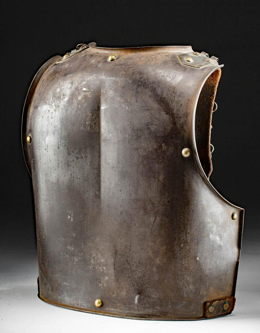 19th C. French Cuirass Armor Iron Back Plate w/ Straps: Western Europe, France, ca. early 19th century. An impressive iron back plate part of the cuirass armor worn by French calvary. The large plate curves upward to protect the shoulders, and leather stra