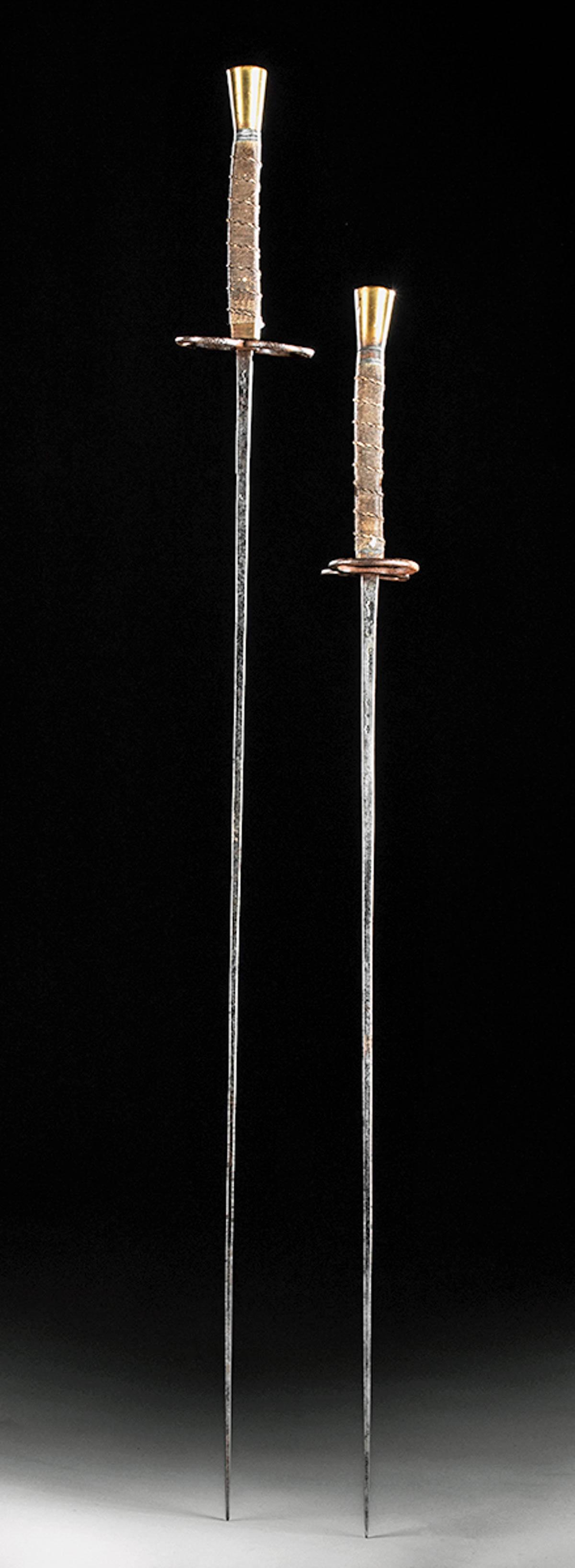 19th C. French Fencing Foils Brass Handles (2): Western Europe, France, ca. second half of the 19th century CE. A fine set of French fencing foils with one bearing a slightly longer blade. Each lengthy handle is composed of a conical brass pommel a