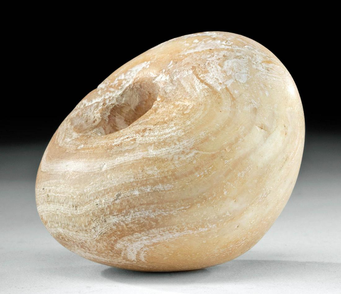 Egyptian Pre-Dynastic Banded Alabaster Mace Head: Ancient Egypt, Pre-Dynastic period, Naqada III, ca. 3200 to 3000 BCE. A hefty mace head carved from honey-yellow alabaster with integral opaque white banding throughout the apple-shaped body. The cent