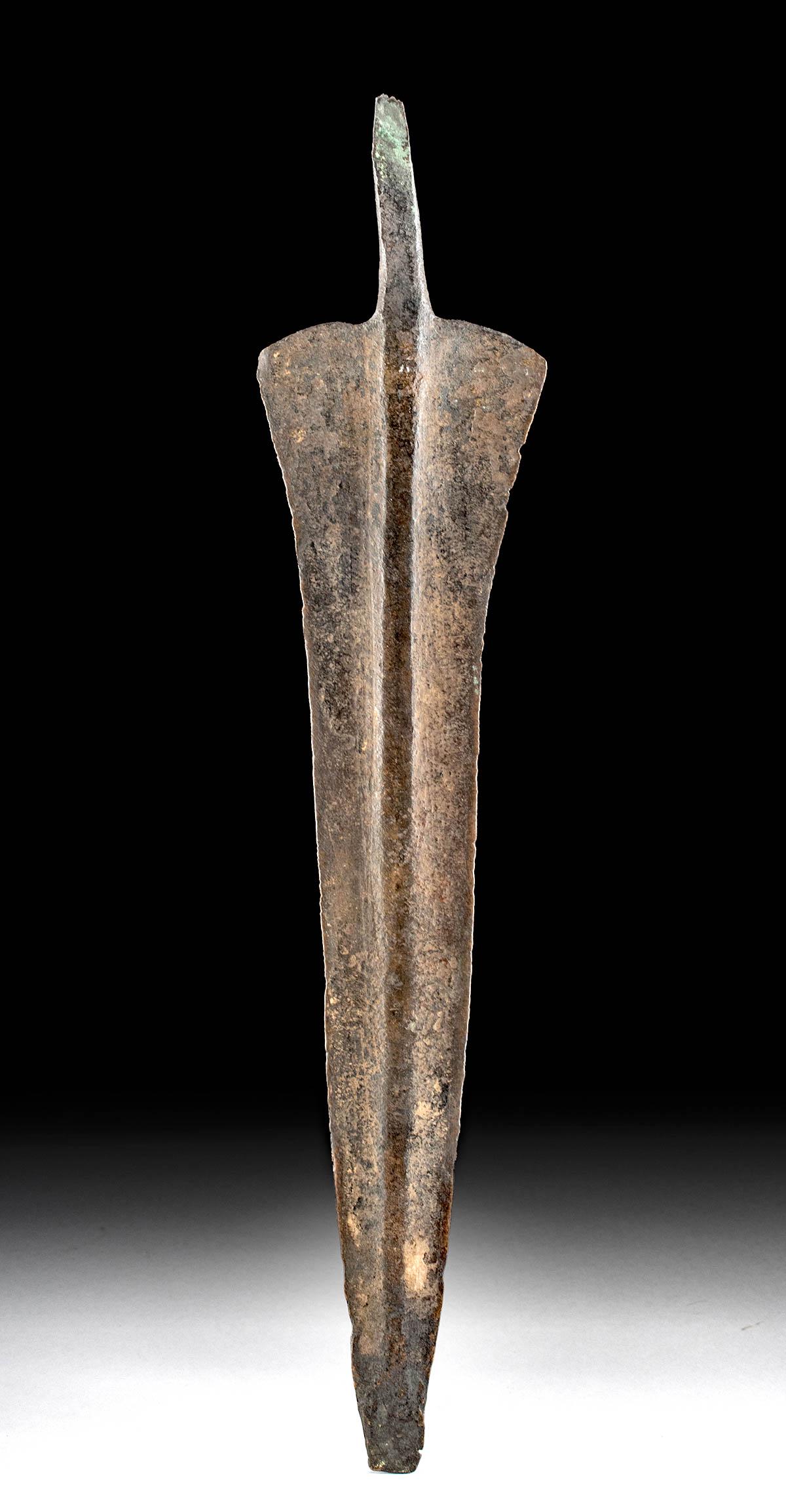 Ancient Luristan Iron Spear Blade Leaf-Shaped: Ancient Near East, Northwestern Iran, Luristan, ca. 1000 to 600 BCE. An iron spear head with a leaf shaped blade and a short tang. A prominent midrib runs the length of the spear from the top of the t