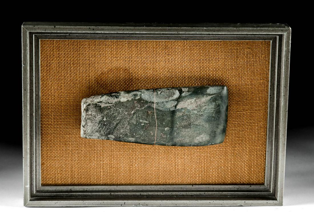 Native American Woodland Stone Axe Head (framed): New World, Native American, found in Craighead County, Arkansas, Middle Woodland Culture, ca. 100 BCE to 400 CE. A handsome example of a dark grey-green stone axe head of simple form, smoothed and pol