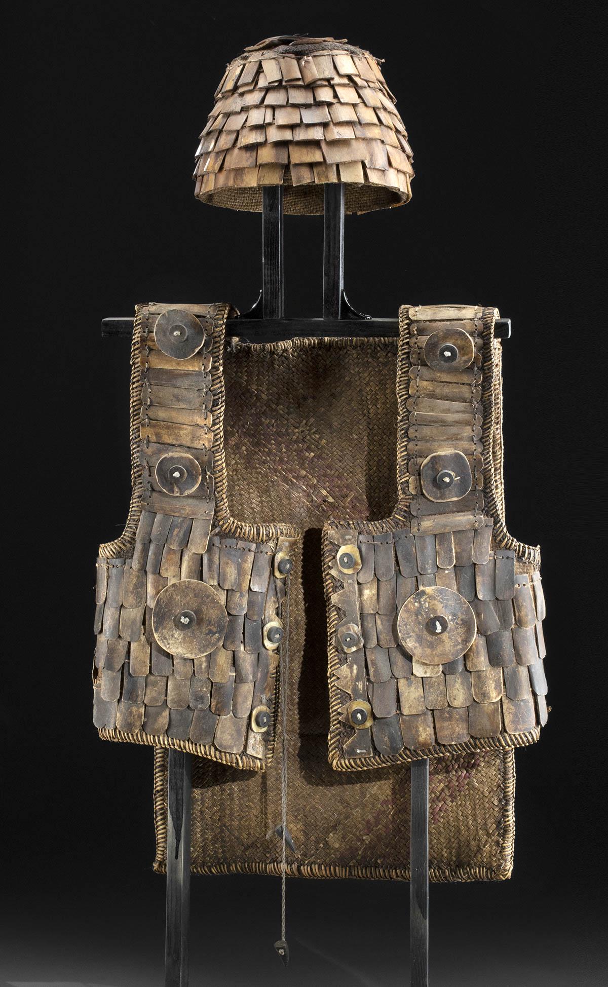 20th C. Sulawesi Island Sa'dan / War Suit + Helmet: Southeast Asia, Indonesia, Sulawesi Island, Toraja people, ca. second quarter of the 20th century CE. A lovely armor vest known as a sa'dan (literally "war suit") with braided rattan fibers forming th