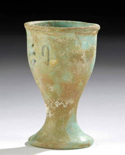 Egyptian Glazed Faience Offering Cup w/ Inscription: Ancient Egypt, New Kingdom period, 19th to 20th Dynasty, ca. 1292 to 1076 BCE. A hand-built faience offering cup of a petite form with a flared foot, a conical body, and a thick rim surrounding the