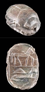 Egyptian Stone Scarab w/ Incised Animal Motifs: Ancient Egypt, Third Intermediate to Late Dynastic Period, ca. 1070 to 332 BCE. A black hand-carved stone scarab amulet with a suspension hole drilled through lengthwise allowing it to be worn on a