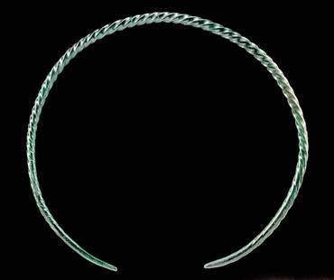 Fine Thracian Leaded Bronze Twisted Neck Torq: Northern Greece / Danube River Valley, Thrace, Iron Age, ca. 7th century BCE. An elegant torq (also torc) shaped from a thick leaded bronze wire that twists several times along the main body. The