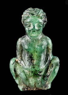 Miniature Egyptian Ptolemaic Greenstone Amulet of Baubo: Egypt, Ptolemaic Period, ca. 332 to 30 BCE. An adorable example of a miniature amulet carved from mottled forest green stone with black inclusions depicting Baubo, the elderly Greek trickster goddess