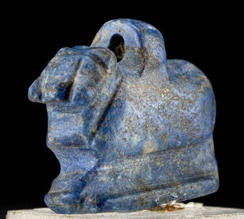 Egyptian Sodalite Amulet Ram Form, ex-Royal Athena: Ancient Egypt, Late Period, ca. 664 to 332 BCE. A beautiful, hand-carved sodalite ram with a petite integral loop upon its back for wearing as an amulet. Carved from a single piece of stone incised