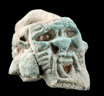 Egyptian Glazed Faience Janiform Bes Head Fragment: Egypt, Late Dynastic Period, 26th to 31st Dynasty, ca. 664 to 332 BCE. A mold-formed faience Janiform head depicting the expressive face of Bes, the dwarf god meant as a protector of women and