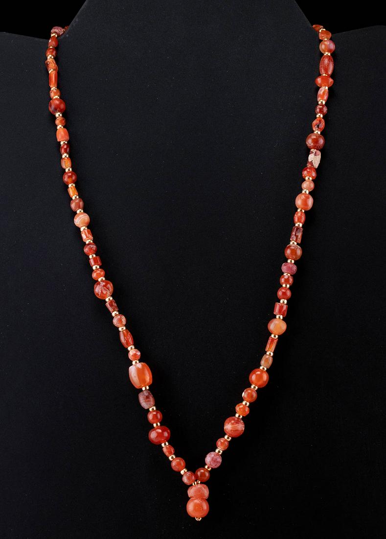 Wearable Roman Carnelian & Glass Bead Necklace: Roman, Imperial Period, ca. 1st to 3rd century CE. A highly wearable and lovely necklace comprised of over 70 ancient carnelian and glass beads. The beads range in size and shape from spherical, seed,