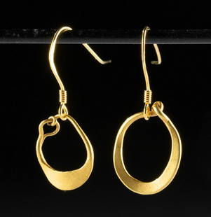 Lovely Pair of Roman Gold Hoop Earrings: Roman, Imperial Period, ca. 1st to 3rd century CE. Two gold 96.6% (equivalent to 23K+) earrings with a flat profile and hoop form. Each earring is comprised of a singular gold wire that has been