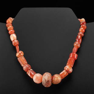 Wearable Roman Carnelian Bead Necklace: Roman, Imperial Period, ca. 1st to 4th century CE. A wonderful gathering of dozens of hand-carved and hand-polished carnelian beads of various shapes and hues. The beads range from lozenge, tubular,