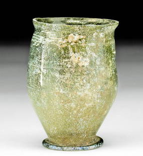 Roman Glass Footed Goblet - Wheel-Cut Decorations: Roman, Imperial period, ca. 1st century CE. A charming cup comprised of incredibly thin, translucent, olive-green glass, its graceful form with a curved profile, two thin, wheel cut bands around the