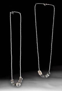 Roman Stone / Glass Bead Necklaces (pr): Roman, Imperial Period, ca. 1st to 5th century CE. A pair of graceful necklaces, each featuring ancient stone and glass circular and barrel-shaped beads, ranging from pale grey to jet black hues.