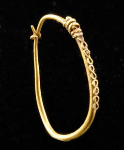 Roman Gold Earring w/ Filigree: Roman, early Imperial Period, ca. 1st to 2nd century CE. A fine hoop earring formed from 82% gold wire (equivalent to 18K+). The ovoid accessory has a thin terminal that fits within a narrow loop,