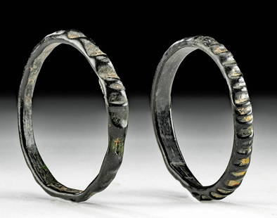 Lot of 2 Petite Roman Black Glass Bracelets: Roman, Imperial Period, ca. 1st to 4th century CE. A lovely and rare pair of petite glass bracelets of circular forms, both in a deep black hue and incised with decorative horizontal ridges along