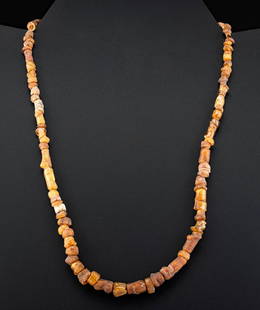Elegant Roman Glass Bead Necklace: Roman, Imperial, ca. 1st to 3rd century CE. A beautiful necklace comprised of glass beads of cylindrical, barrel, discoid and other diverse shapes in hues of caramel, sienna, and creamy beige.
