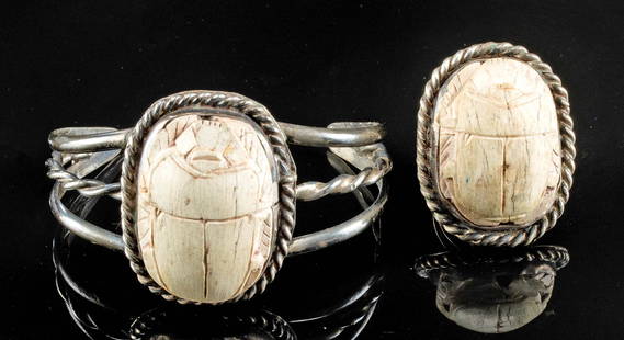 Egyptian Stone Scarabs in Silver Bracelet & Ring: Ancient Egypt, New Kingdom, 18th to 20th Dynasty, ca. 1550 to 1070 BCE. A silver bracelet and ring, each featuring sizable scarab pendants carved from stone of a creamy-beige hue and surrounded by