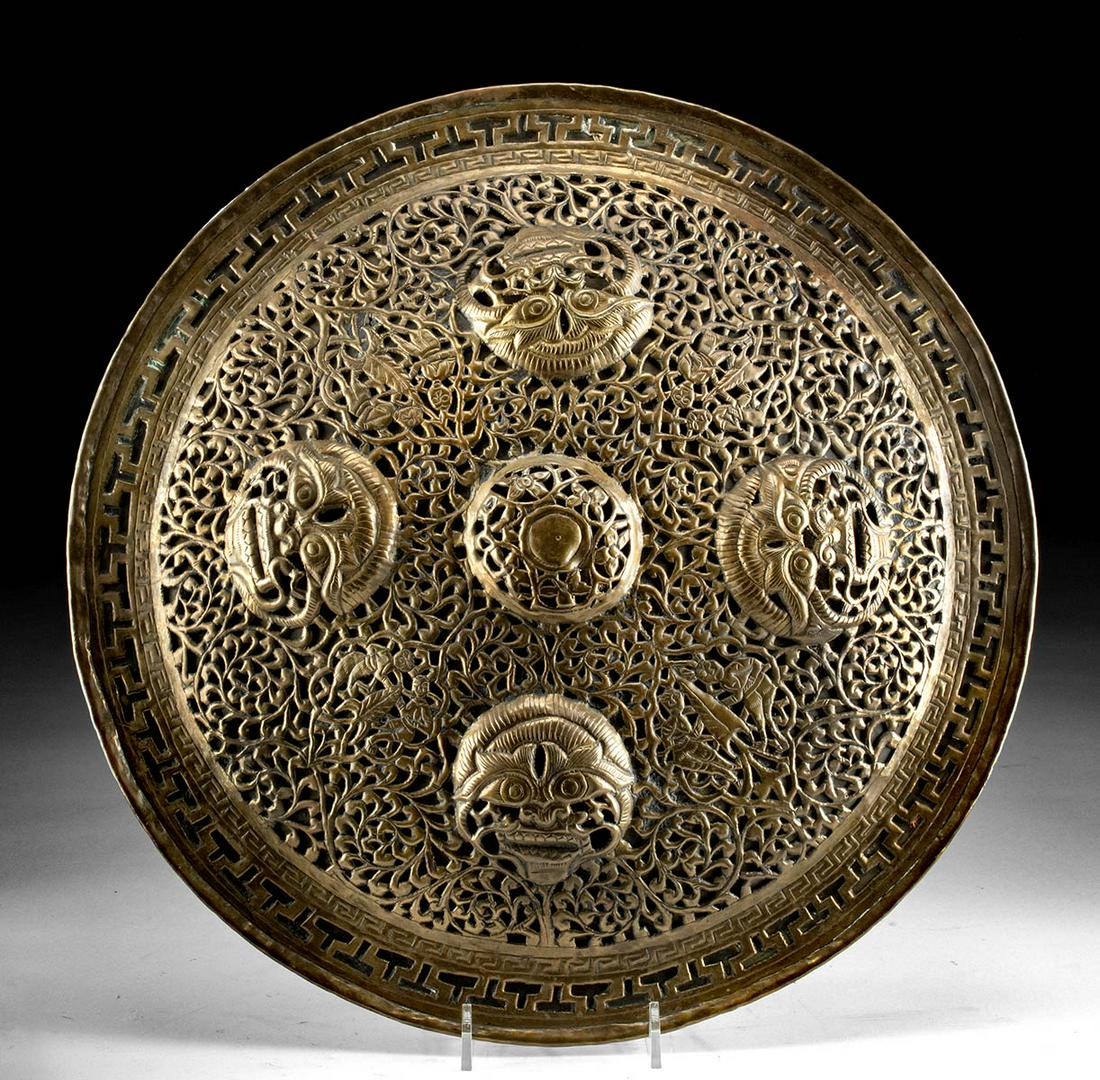 Antique Indian Brass Dahl / Shield with Monster Heads: Central Asia, Pakistan/northern India, Indo-Persian period, ca. 19th century CE. An attractive brass shield known as a dhal, a form of buckler, or small shield made to be gripped with a central handle