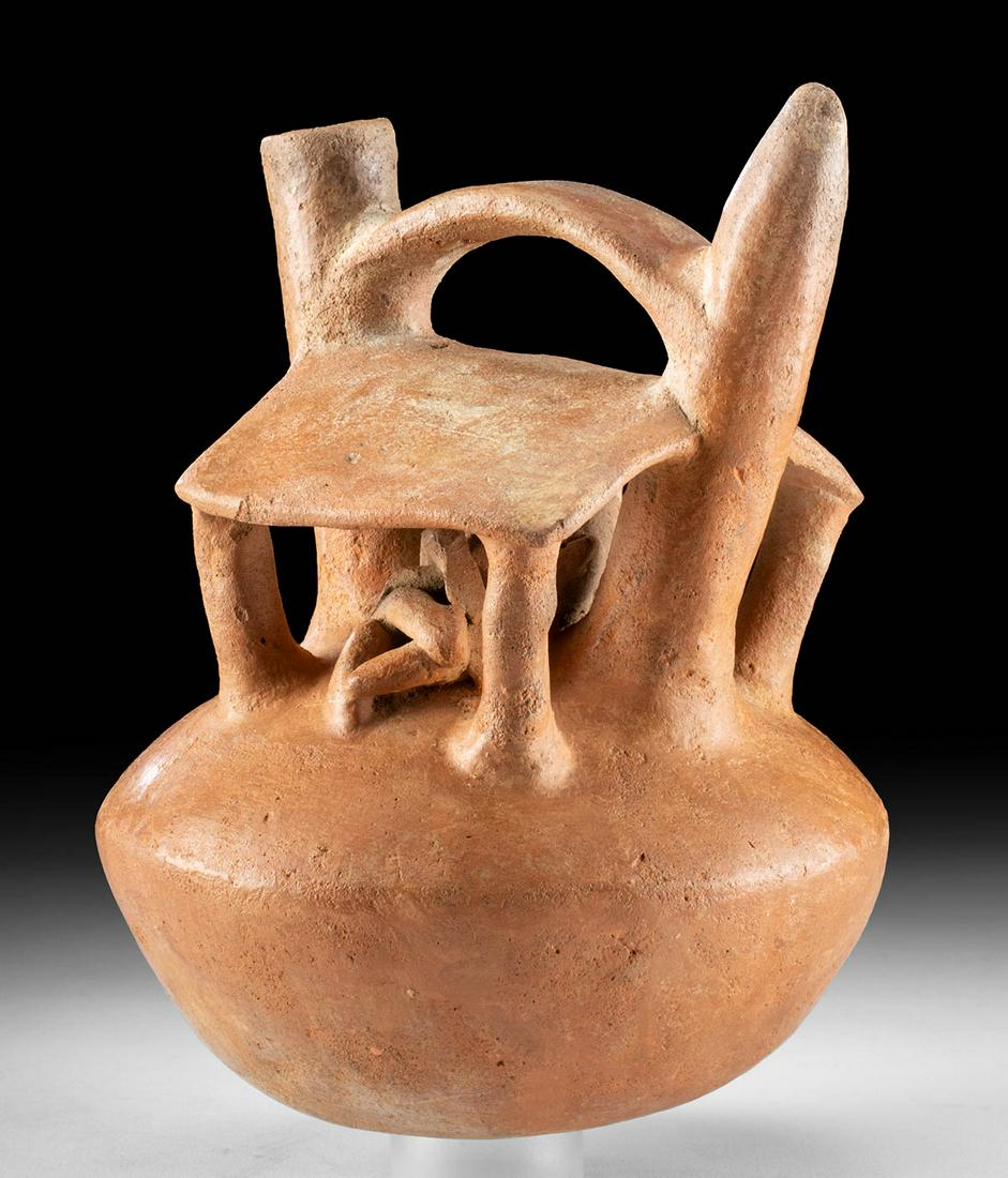 Salinar Terracotta Stirrup Vessel w/ Erotic Scene: Pre-Columbian, North Coast of Peru, Salinar culture, ca. 500 to 300 BCE. A hand-built terracotta stirrup vessel depicting a house with open walls; under its roof are two reclining figures that are int