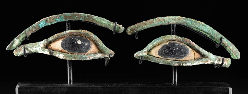 Egyptian Copper Alloy & Limestone Eyes from Sarcophagus: Egypt, Late Dynastic Period, 26th to 31st Dynasty, ca. 664 to 332 BCE. A pair of watchful leaded-copper and limestone eyes and brows. The leaded-copper rims encircle the limestone eyes, and the outer