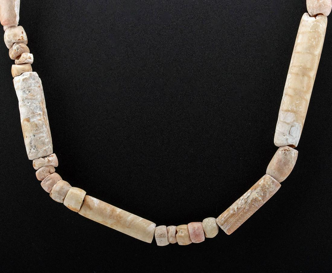 Wearable Colima Bone & Shell Necklace: **First Time At Auction** Pre-Columbian, West Mexico, Colima, ca. 200 BCE to 400 CE. A fine collection of shell and ungulate bone beads that were perhaps part of an ancient piece of burial jewelry. Th