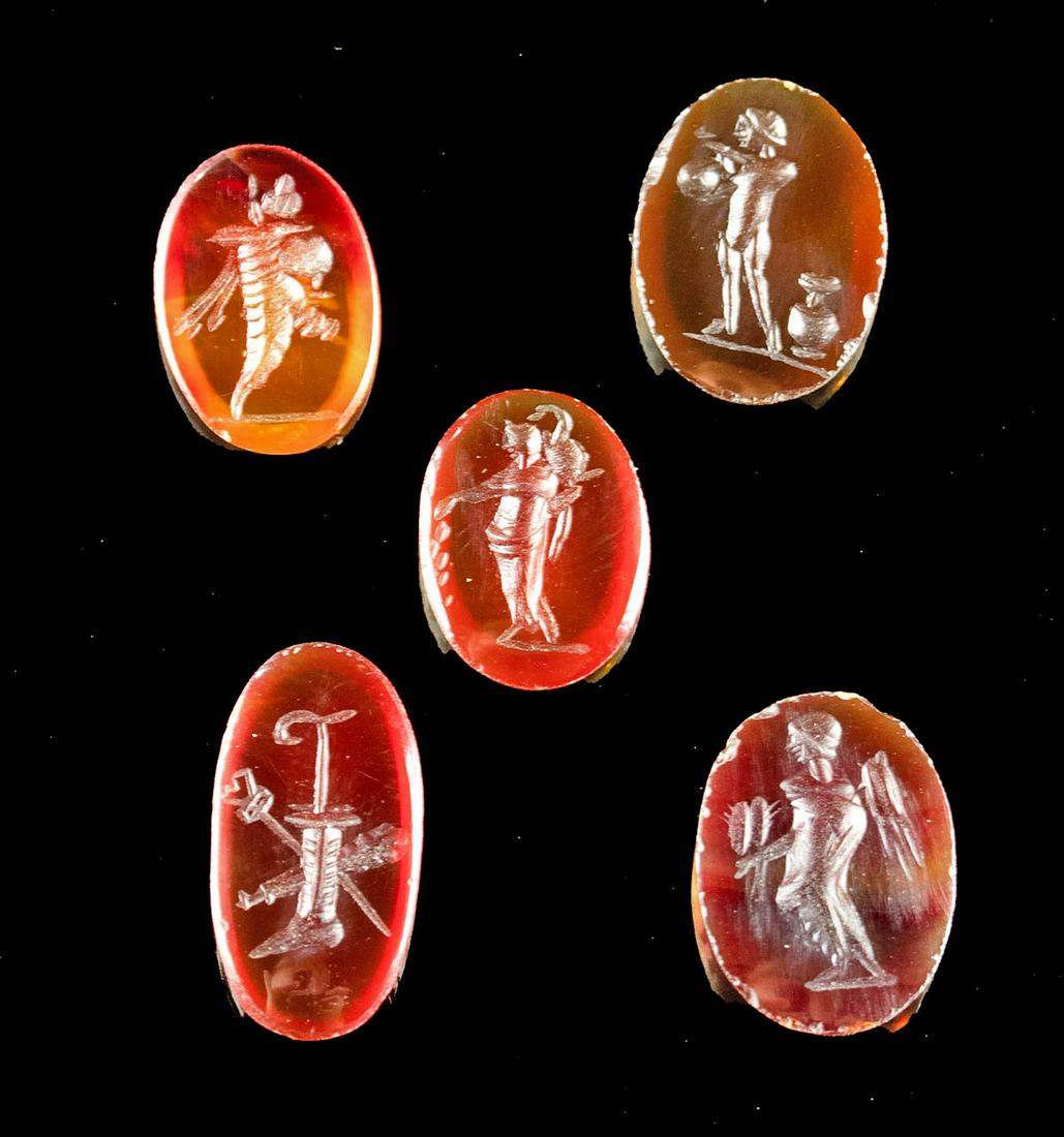 Lot of 5 Neoclassical Carnelian Intaglio Cabochons: Europe, Neoclassical, ca. late 18th to early 19th century CE. A gorgeous ensemble of five carnelian intaglio cabochons, all of ovoid form and presenting with lovely hues of red, ranging from cardinal 